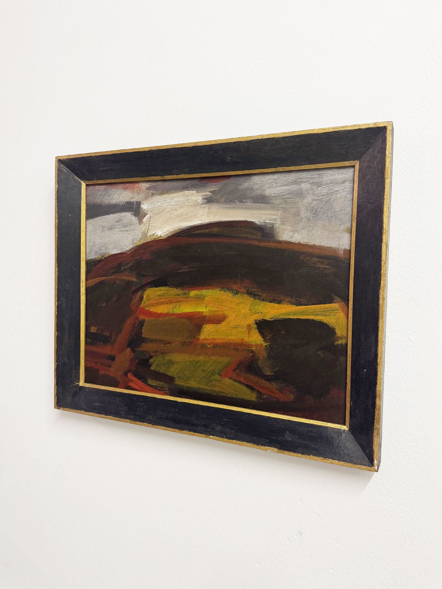 Original mid century Swedish style abstract landscape by Geoffrey Bargery with bold earthy tones and dramatic sky, framed in black wood with gold edging.