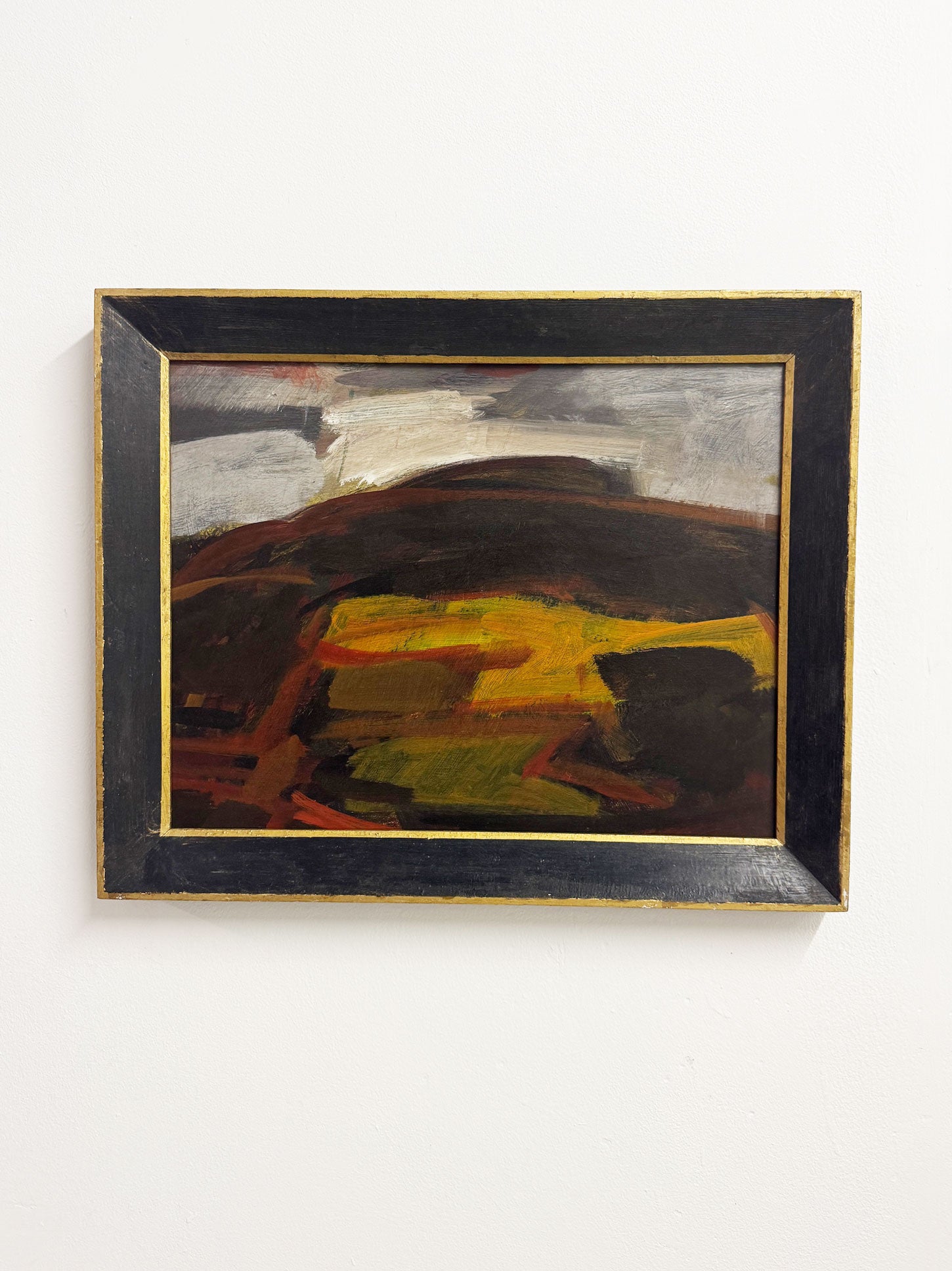 Original mid century Swedish style abstract landscape by Geoffrey Bargery with bold earthy tones and dramatic sky, framed in black wood with gold edging.
