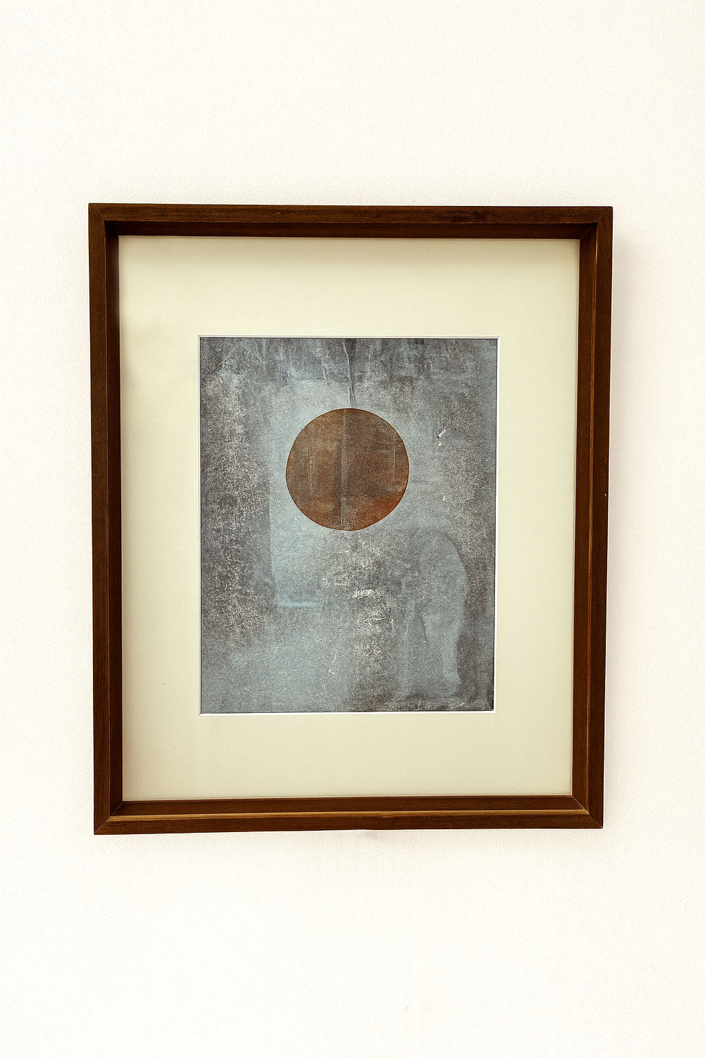 Mid-century abstract monotype with centered circle on textured gray-blue, symbolizing balance and calm, in vintage wooden frame.