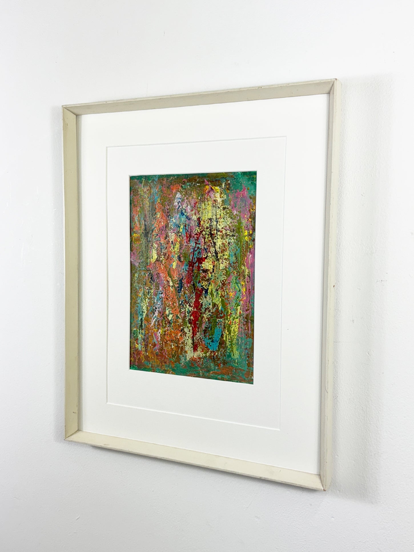 Colorful abstract painting with textured acrylic layers in orange, green, turquoise, and gold, framed in white wood.