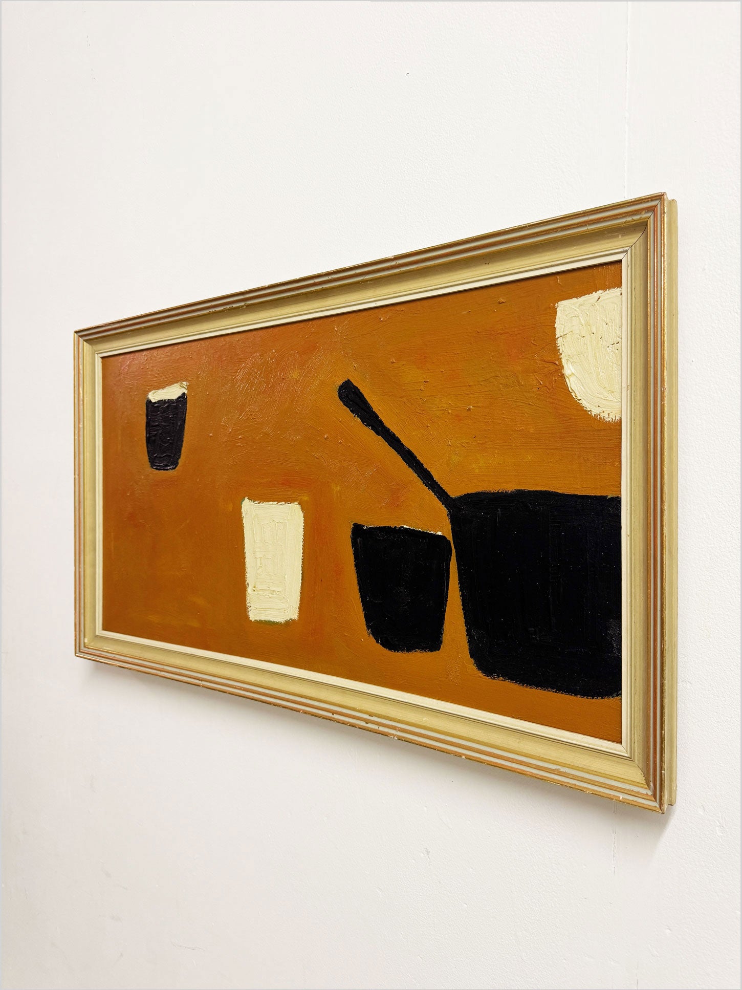 Modernist still life in the style of William Scott with black and cream vessels on an ochre-orange background.